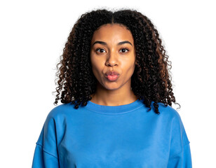A young woman with curly hair in a blue top, pouting her lips and looking directly at the viewer against black bg