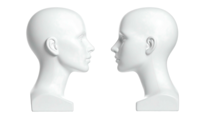 Two plain white mannequin heads face each other against a black backdrop in a symmetrical studio shot