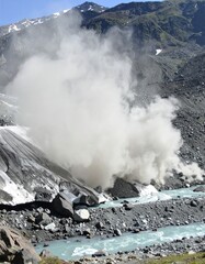 Glacial silt plume in turquoise river flowing from melting ice in high mountain valley