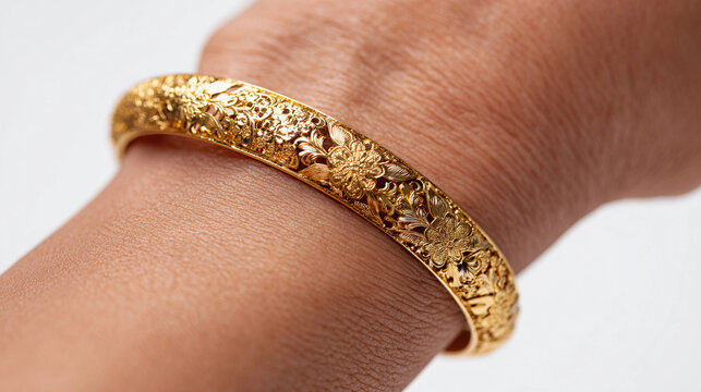 traditional Indian gold kada (bangle) worn on a woman&rsquo;s hand
