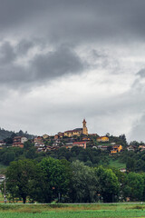 Fototapeta premium Picturesque hillside village under cloudy sky