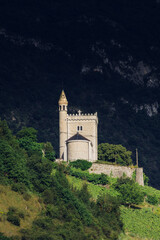 Scenic road leading through a forest and rolling hills towards misty mountains, bathed in soft sunlight. A perfect drive through nature s tranquility and beauty.