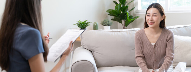 Young woman in a mental therapy session talking with a psychologist in the office.