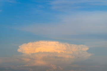 A Majestic and Imposing Cumulonimbus Cloud Looms Overhead Against Clear Blue Skies
