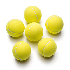 A top view of six yellow tennis balls arranged on a white surface with visible shadows beneath them