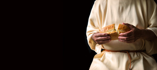 Naklejka na ściany i meble Man's hans holding fresh bread Naklejka na ściany i meble Man's hans holding fresh bread