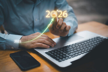 Businessman touching 2026 with arrow target icon, representing new year business goal, strategic...