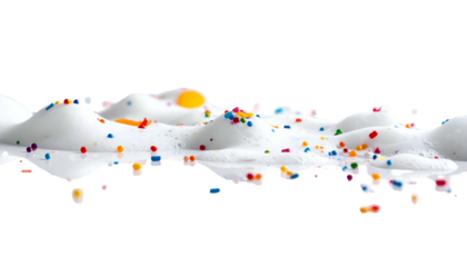White, foamy substance with colorful sprinkles against a stark black backdrop