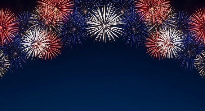 Vibrant red white and blue fireworks bursting in a dark night sky