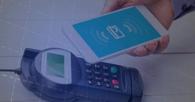 Processing contactless payment with smartphone held over POS terminal on wooden counter, copy space
