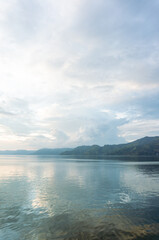 Lake Serenity A Calm Water Reflection Under Cloudy Skies