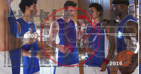 Five athletes in matching jerseys discussing strategy at gym, with basketball, tablet, red overlay