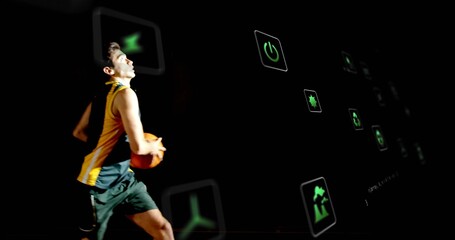 Dribbling male basketball player holding ball in dark gym, with floating digital icons, copy space
