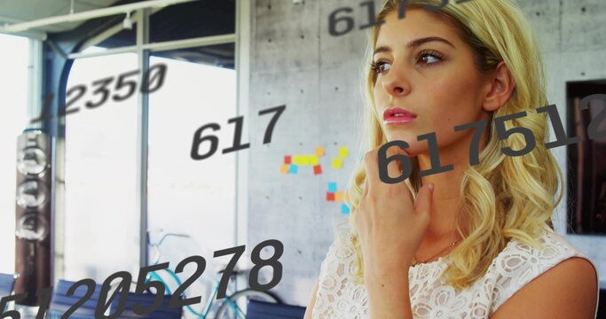 Standing woman gazing in office with bicycle by accent wall, sticky notes and numeric overlays