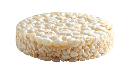 A close-up shot of a round, puffed grain cake with a light beige color, isolated on black