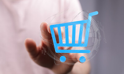 Hand reaching out to a digital shopping cart. Represents online shopping, e-commerce, and digital...