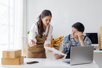 Asian couple discussing finances, having an argument, and experiencing stress while running their...