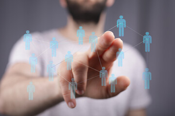 Visual representation of interconnected individuals and community concept. Hand interacting with a network, ideal for business and technology.