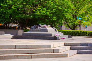 Ottawa, ON, Canada. October 21, 2025: The Tomb of the Unknown Soldier at Canada's National War Memorial in Ottawa, surrounded by trees and urban architecture in a serene plaza