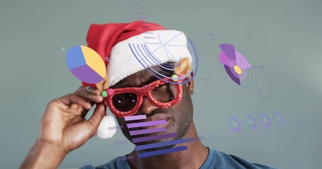 Man wearing Santa hat picking reindeer glitter glasses, adjusting and causing drifting data visuals - Powered by Adobe