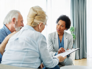 Fototapeta premium Portrait of a businesswoman or real estate agent or doctor shaking hands and signing a deal contract with senior couple in his office