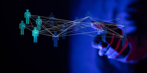 Abstract image of hand interacting with a network of connected human figures, representing technology, teamwork, and business networking.