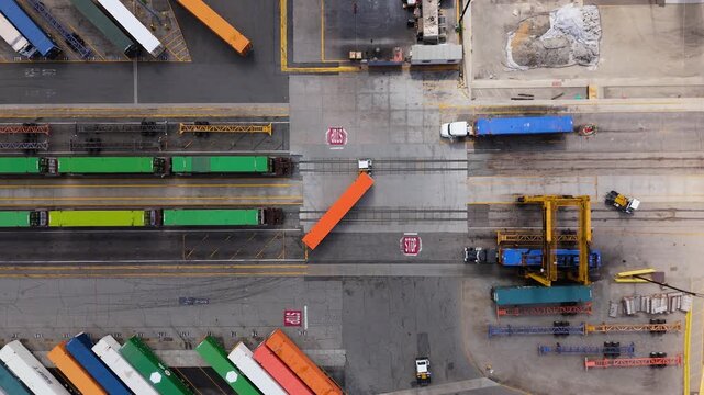 Aerial view of cargo trucks and freight trains at logistics terminal in 7 October 2025