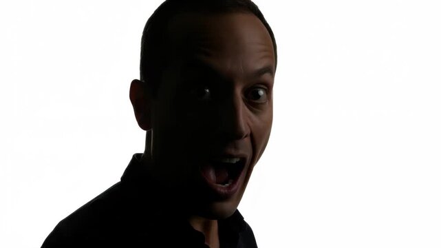 Dramatic shift from joyful expression to shadowed silhouette of a man