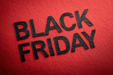 Black Friday promotional text featuring bold black textured letters displayed prominently on a vibrant red background. Ideal for seasonal sales campaigns.