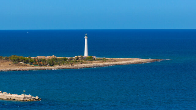 Aerial view of the white lighthouse of San Vito Lo Capo, on the coastline of the province of Trapani, Sicily, Italy. It is a lighthouse on the Tyrrhenian Sea coast. 