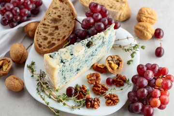 Gorgonzola cheese with walnuts, red grapes, and thyme.