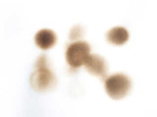 Burned paper with black scorch stains and aged texture. Paper burned with black marks. Old stained paper showing fire damage and discoloration.