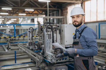 Factory worker checking aluminum and pvc windows and doors production line