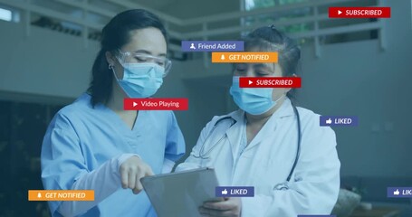 Two medical staff tapping tablet discussing patient data overlays appearing on Send Message prompt