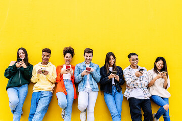 Multiracial young friends having fun sharing media content on mobile phone. Communication and social media concept