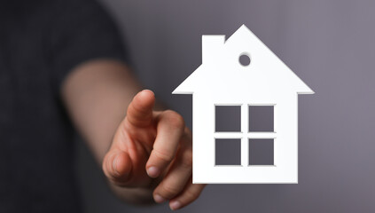 Hand touching house symbol. Concept of real estate, ownership, and dream home. Perfect for real...