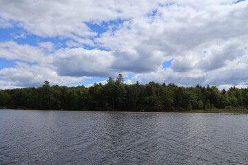 A beautiful cloud formation over a lake in the Adirondacks on a sunny day.