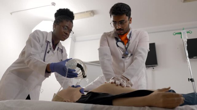 Medical students practicing CPR and breathing support on a dummy