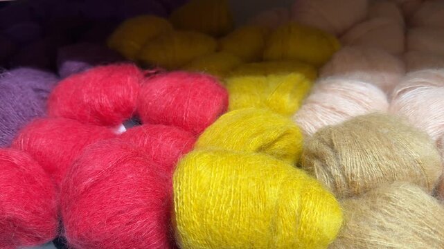 Colorful skeins of wool yarn in various shades, perfect for knitting projects or crafting