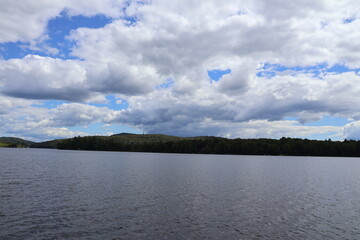A beautiful cloud formation over a lake in the Adirondacks on a sunny day.