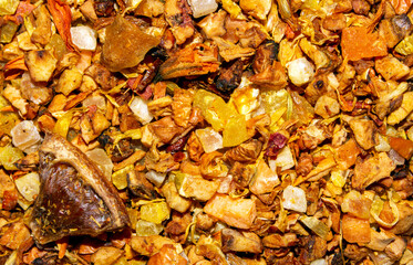 Sea buckthorn tea leaves with pieces of fruit.Sea buckthorn tea with lemon.The texture of sea buckthorn tea.