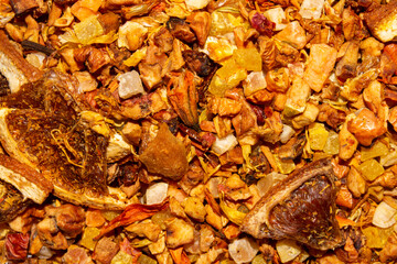 Sea buckthorn tea leaves with pieces of fruit.Sea buckthorn tea with lemon.The texture of sea buckthorn tea.