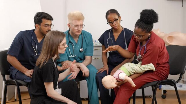 Medical students learning infant cpr training procedures