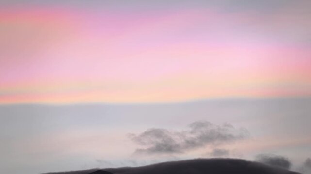 Rare nacreous clouds glow and ripple at sunrise. Pearlescent sheets flowing across the cold stratosphere