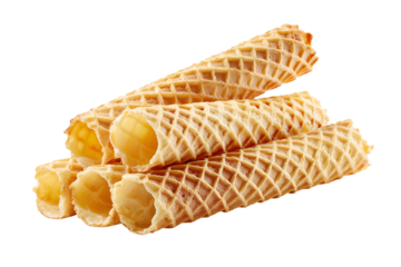 Stack of golden crispy wafer rolls filled with sweet cream on a black background