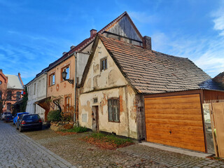 Charming old European street with historic buildings and cars
