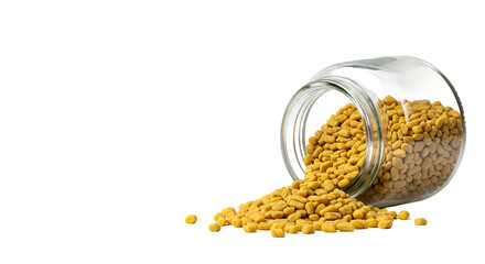 Fenugreek Seeds Spilling from Glass Jar Onto Warm Golden Background
