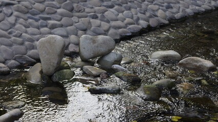 Balancing stones in water in a city park