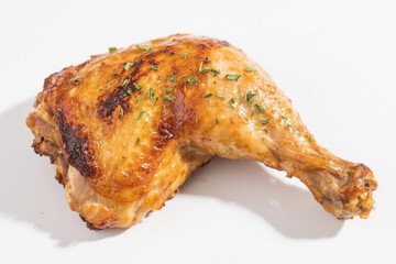 Delicious golden brown roasted chicken leg with crispy skin and fresh herbs, placed naturally on a pure white background, highlighting its juicy texture and rich, appetizing caramelized color.