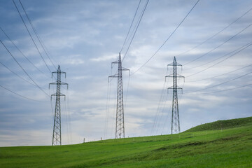Power lines on a grassy ridge